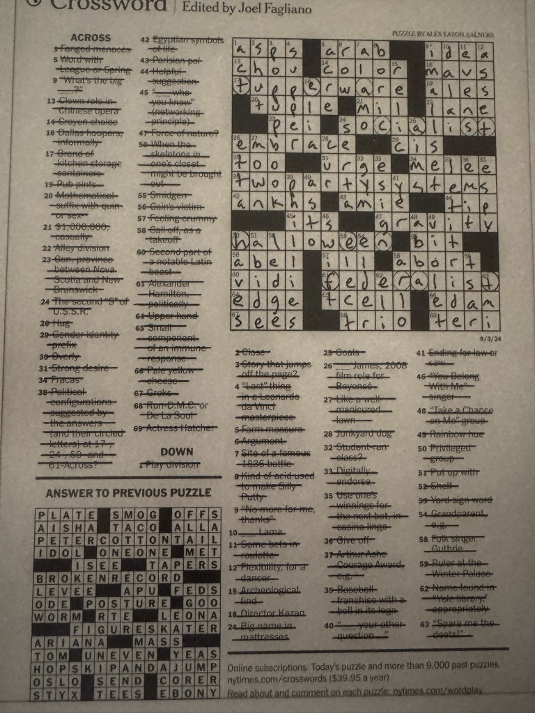 E-ink tablet showing a New York Times crossword with clues crossed out in straight lines